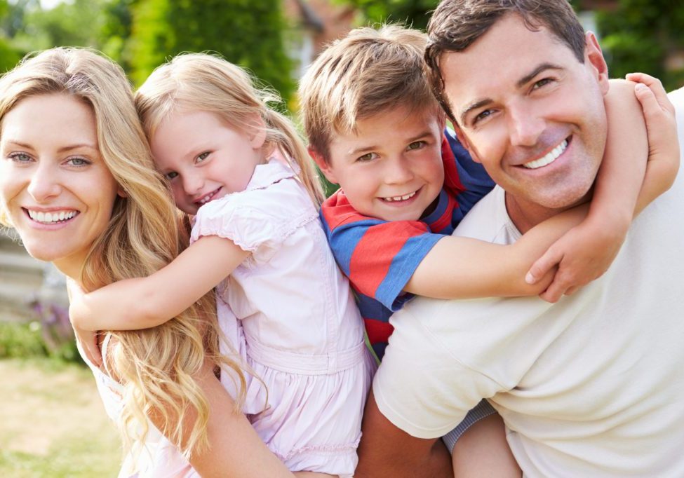 Portrait Of Happy Family In Garden